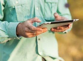 Man outside with tablet