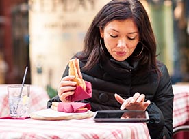 Woman at lunch on tablet